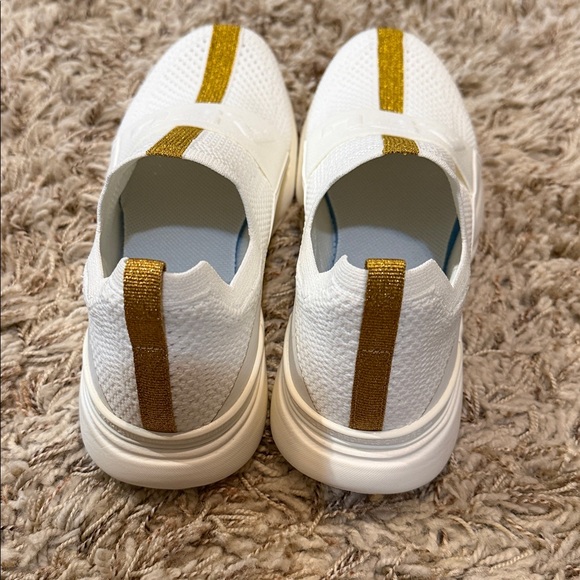 APL Tech Loom Bliss White Slip-On Knit Sneakers with Gold Stripe. Size 7